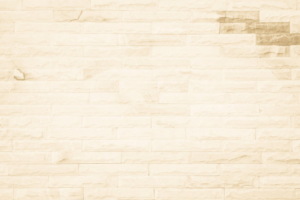 宽奶油色砖墙纹理的空背景。米色旧棕色砖墙混凝土或石材纹理，壁纸石灰石抽象地板/网格不均匀的内部岩石。家居装饰设计背景。图片下载