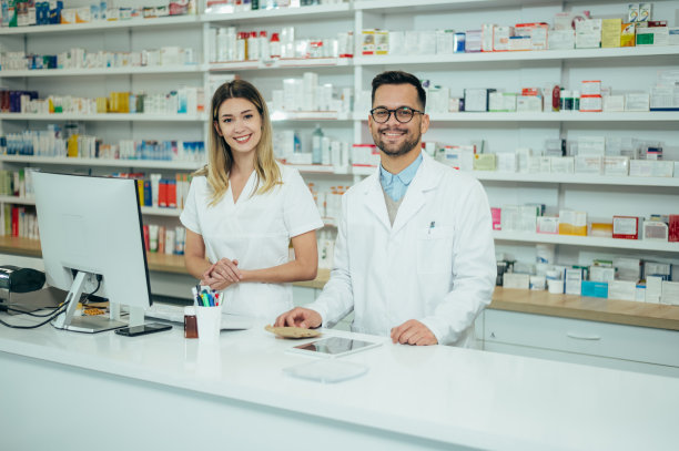 快乐的年轻男女同事，药剂师在一家药店工作图片下载