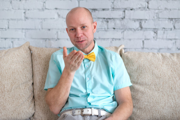 爱在自我隔离的家中。一个快乐优雅的男人在一个浪漫的虚拟约会中向他的爱人飞吻在情人节自我隔离图片下载