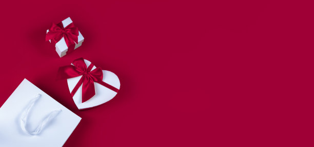 横幅上有一个红色背景上心形的礼品盒。情人节礼物概念，宽横幅与文字空间。概念-促销、促销、购物图片下载