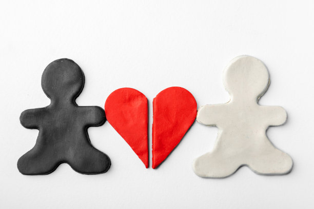 用黑白橡皮泥做成的小人手里拿着半瓣蓝色背景的红色橡皮泥心图片下载