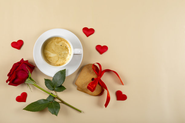 咖啡杯，心形饼干和米色背景上的红玫瑰，俯视图，文本的自由空间图片下载