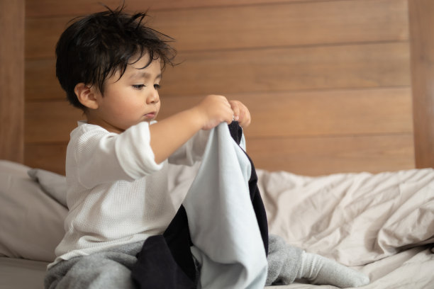 墨西哥2岁婴儿洗澡后学习穿衣服图片下载