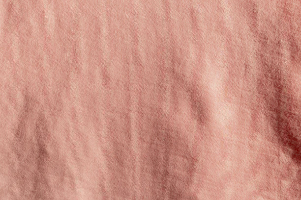 织物背景与粉红色织物涤纶织物纹理。图片下载