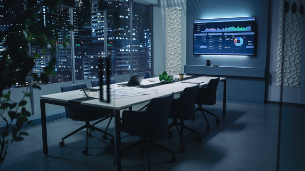 现代的空会议室，大会议桌上有各种文件和笔记本电脑。墙上电视显示公司的增长，统计，图表和饼图。《深夜》或《夜城》。图片下载