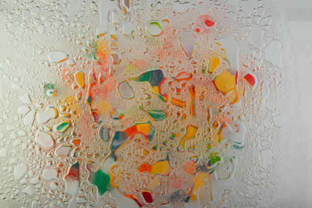 抽象多彩的背景油圈。油在水面上打转，水产生泡沫，油产生气泡。高质量的照片图片下载