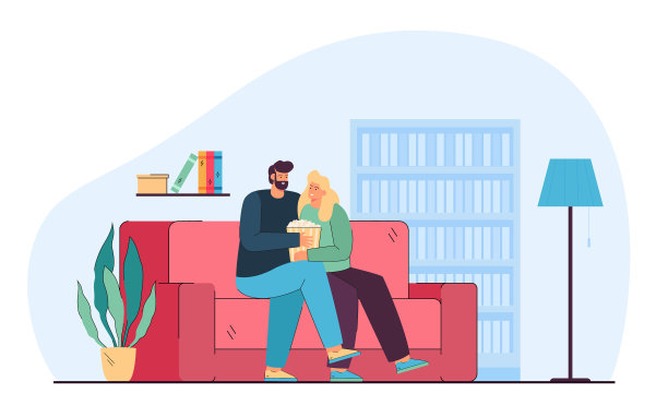 一对情侣一边吃着爆米花一边看电影或电视剧图片下载