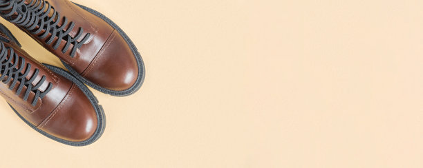 棕色的鞋子。时尚靴子对中性米色背景。复制空间，俯视图，平铺。鞋子大甩卖，时尚理念。都市时尚休闲鞋。切尔西靴子的头顶照。城市的生活方式图片下载