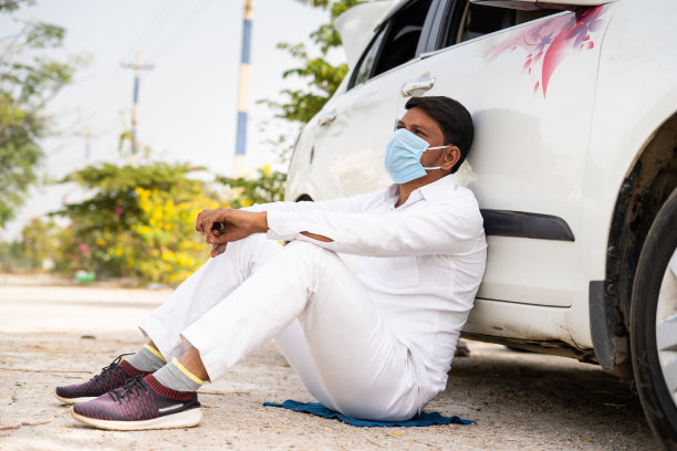 带着医用口罩的出租车司机忧心忡忡地坐在车前思考——失业的概念、思考、封锁covid-19和财务问题图片下载