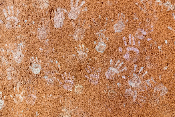 沙哑的棕色墙壁上有许多五颜六色的儿童手印图片下载