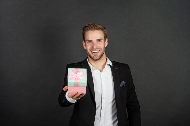 快乐的商人分享礼物盒的男人或女人的节日图片下载