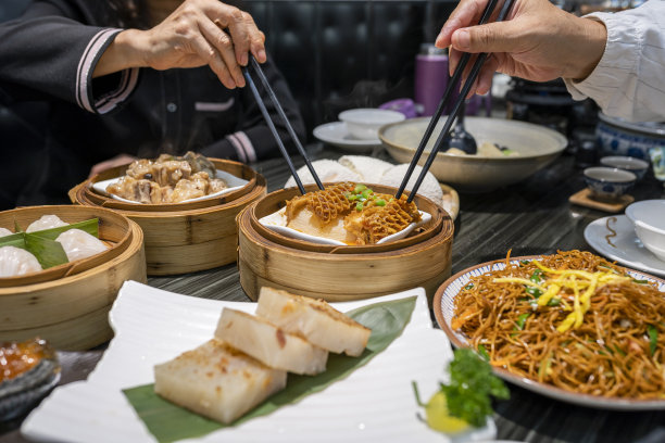 餐馆里用筷子吃广东dum sum的人图片下载
