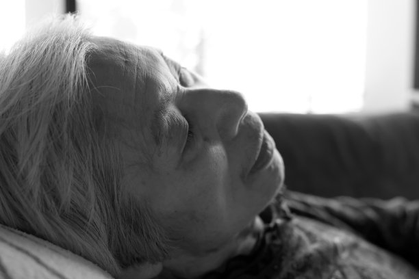一个老年痴呆症妇女躺在护理床上放松的特写图片下载
