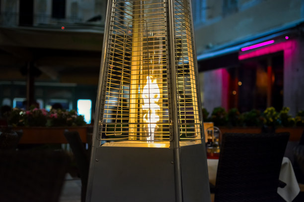 克罗地亚斯普利特(Split Croatia)的一个夜晚，露台上的暖炉发出的火焰温暖了一个小的户外人行道咖啡馆图片下载