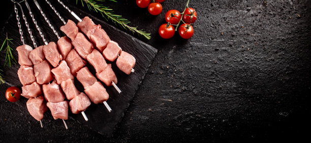 用石头做成的烤猪肉串和西红柿。图片下载