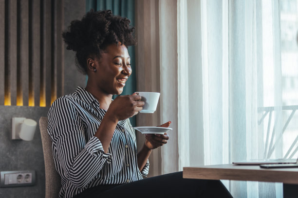 一个微笑的快乐的迷人的美丽的梦想家与一个成熟的女人的黑色卷发的特写肖像图片下载