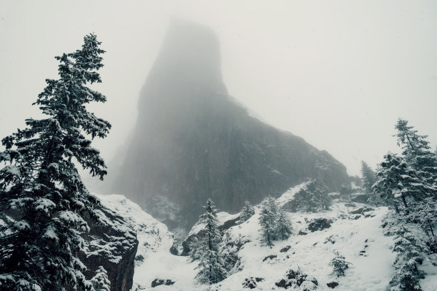 雪天雾中的大石头的照片。图片下载