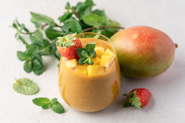 芒果冰沙玻璃杯装饰草莓和薄荷图片下载