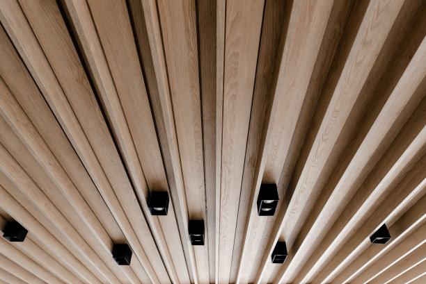 木质镶板的创意天花板，现代的木质吊顶，天花板上的黑色阁楼灯，节能灯泡图片下载