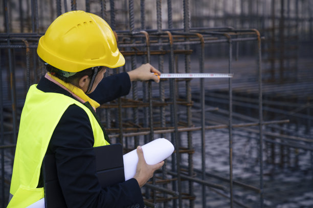 女工程师在工地拿着平板，检查工作进度。测量钢筋。图片下载