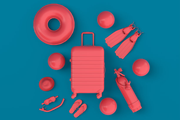 色彩鲜艳的手提箱或行李与海滩配件在蓝色的背景。图片下载