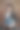一位商务女士穿着正式的西装，手里拿着一台笔记本电脑，背景是节日装饰的木质背景图片下载