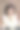 一个深色头发的女人穿着一件带领的黄色夹克，斜靠在一把高皮椅上图片下载
