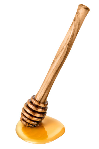 蜂蜜棒与一滩蜂蜜在白色背景上。图片下载