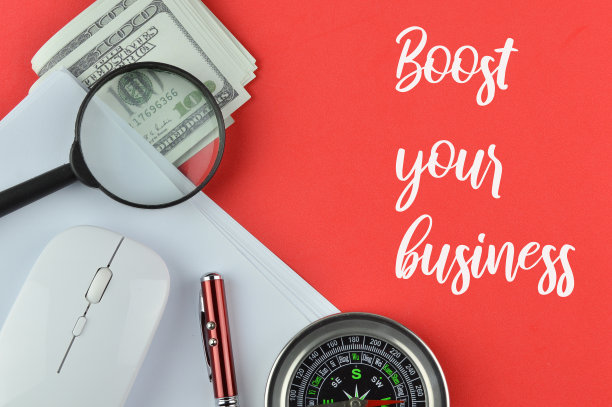 办公室工具在红色背景上写着促进您的业务。图片下载