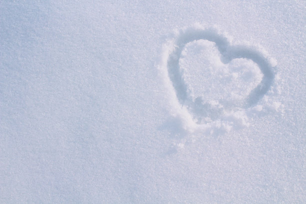 心用手指画在雪地里。特写镜头。背景。纹理。图片下载