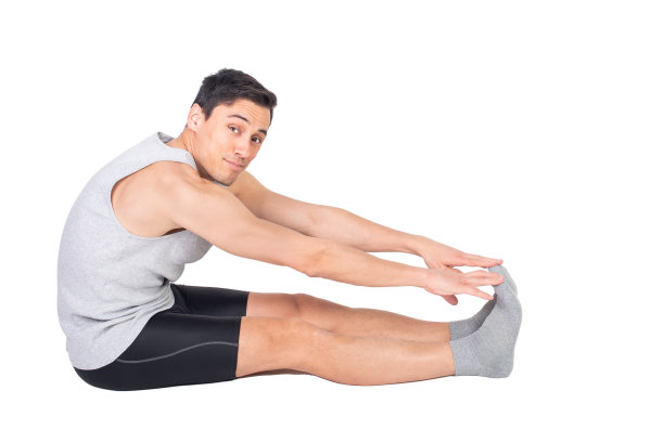 穿着运动服的运动男子，在伸展腿筋图片下载