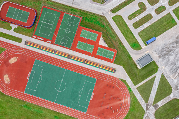 学校运动场周围有足球场、慢跑跑道。篮球，排球，网球场。航拍照片，俯视图。图片下载