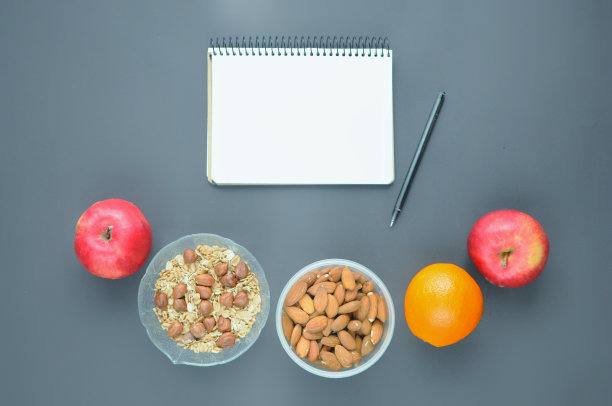 计算健康食物的卡路里:燕麦片、杏仁、苹果、橘子。图片下载
