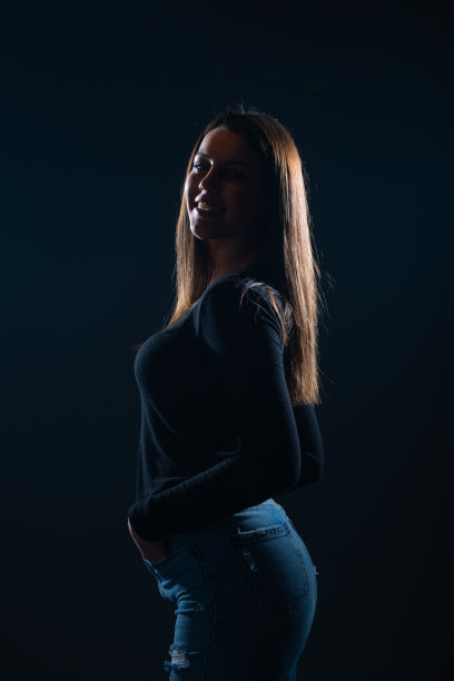 美丽的女人在黑色背景摆姿势的剪影照片图片下载