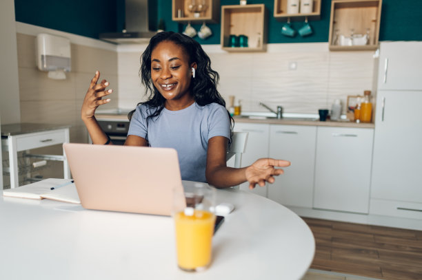 一名年轻的非裔美国女性，在家里用笔记本电脑工作图片下载