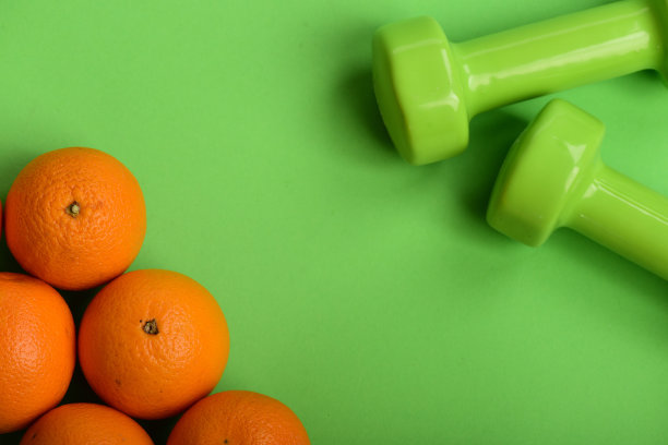 橙色附近的哑铃绿色背景，俯视图。图片下载