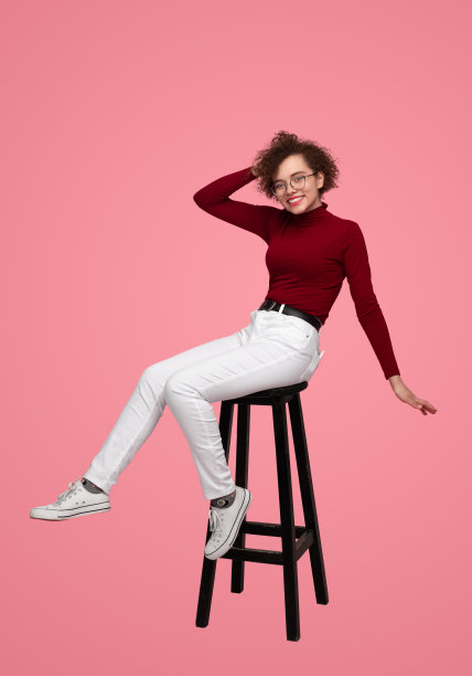 微笑时尚的女人在工作室的凳子上图片下载