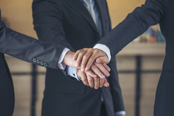 一群多元化的人握着手一起碰拳，力量十足的tag团队。团队合作:多种族的人在一起工作。商务人士团队携手成功。商务会议图片下载