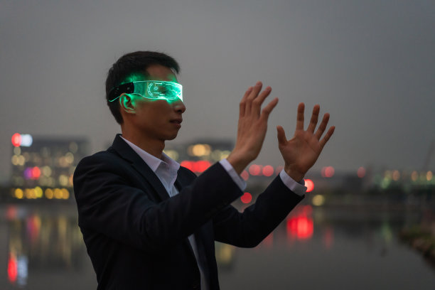 未来科技，男性白领在晚上戴着增强现实眼镜图片下载