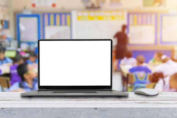 现代化的笔记本电脑，在教室的桌子上有空白屏幕图片下载