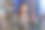 中年男子在笔记本电脑旁边看着自己的手机，露出怀疑的表情。乡村住宅内部与木材燃烧的炉子和堆放的木柴图片下载