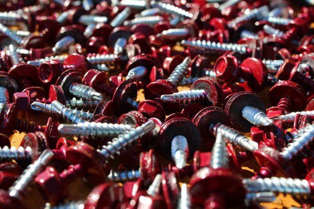 红色大螺帽螺钉放在表面。图片下载