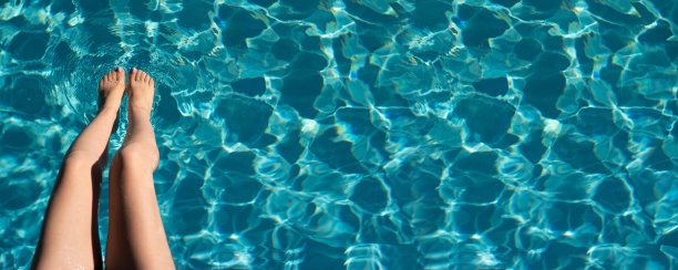 泳池里性感女性的腿。软焦点的背景。暑假。豪华生活方式设计的美丽特写。假期,假期。图片下载