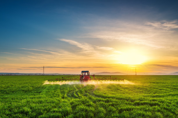 拖拉机在绿地上喷洒化肥农药，农业背景概念。图片下载