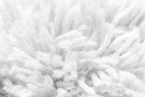 粗纱纹理，浅灰色长纤维地毯的粗镜头。微距摄影的概念图片下载