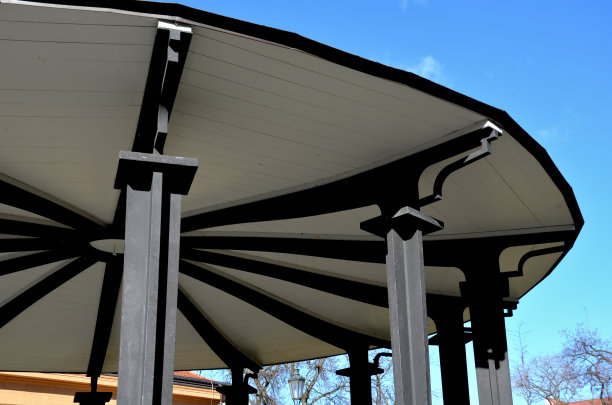 钢结构的凉亭与装饰梁。屋顶是木制的，呈扁平的金字塔形状。圆形的舞池覆盖着花架，音乐亭的露台图片下载