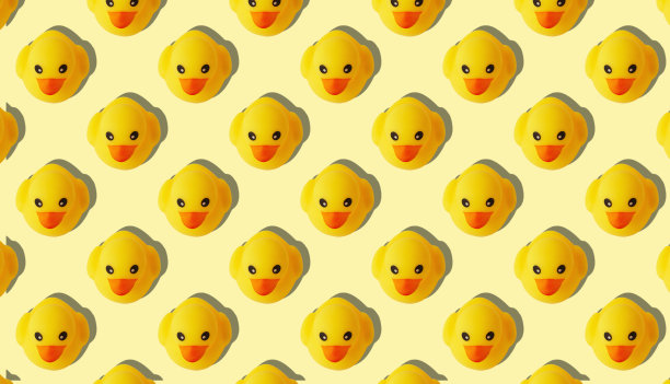 黄色背景上的黄色橡皮鸭图案图片下载