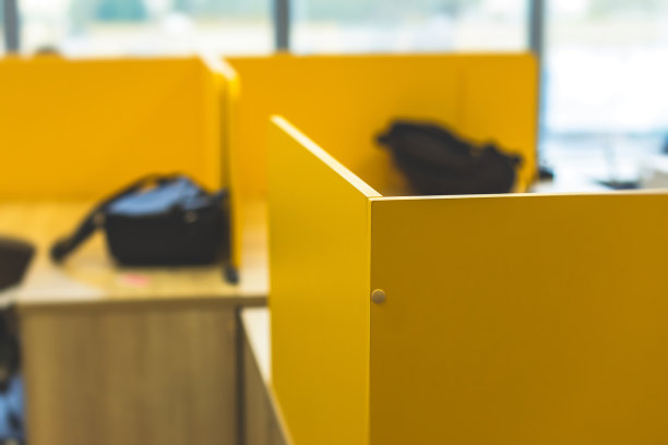 现代办公空间的内部与黄色调的办公桌，员工与笔记本电脑在一个舒适的工作场所的背景，it公司的开放空间与桌子，椅子和房间图片下载