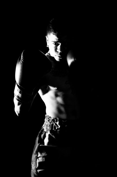 一个年轻人在黑色背景上练习太极拳图片下载