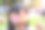 亚洲小女孩幽默地拿着彩虹蛋白糖霜遮住眼睛。图片下载